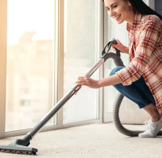 Happy lady cleaning carpet | Myers Flooring of Nashville