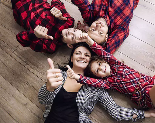 Happy family laying on hardwood floor | Myers Flooring of Nashville